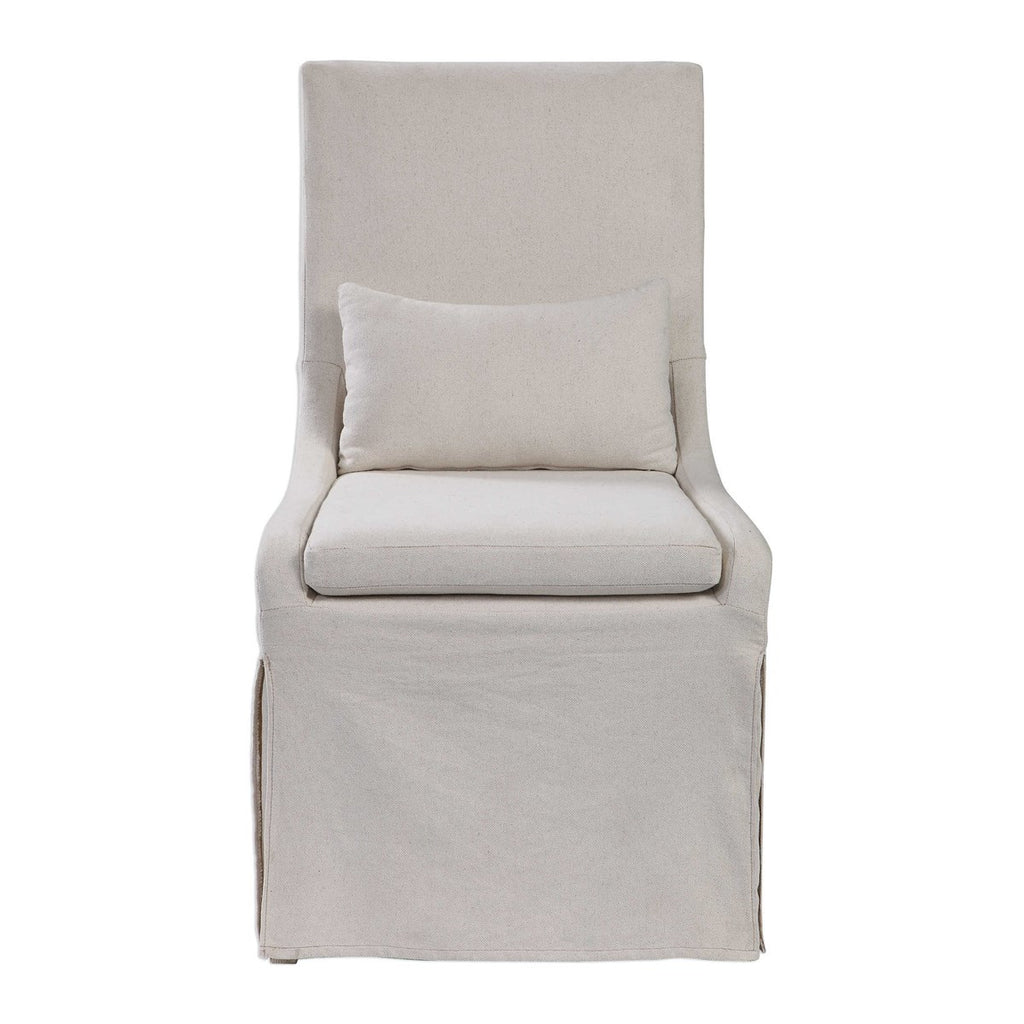 Coley Armless Linen Covered Tailored Chair by Uttermost.  This chair is perfect for dining or accent chair.  Simplistic in form, this casually sophisticated armless chair features a tailored off-white linen blend slipcover with a plush cushion seat and kidney pillow for added comfort. 