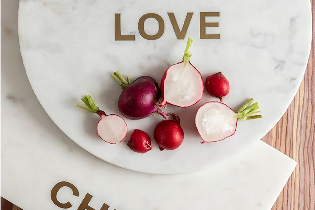 Verona Love Board by BeHome.  Marble serving or cutting board with gold accent with word LOVE.  Top view with food display.  