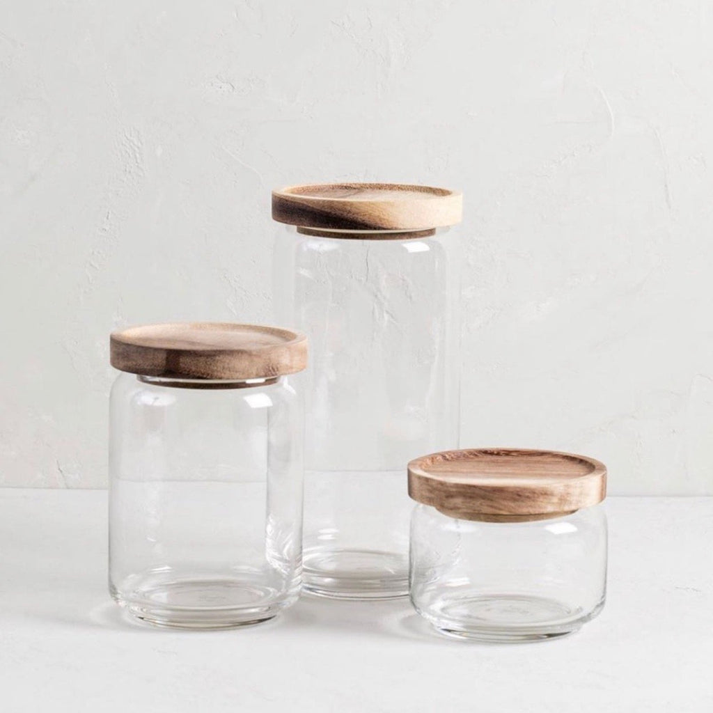 Glass storage container with acacia lid large by BeHome shown with other sizes.