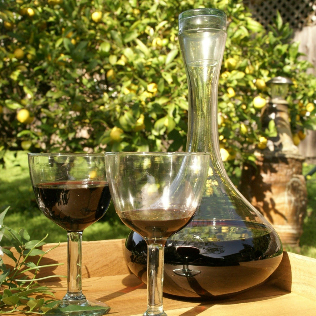 Premium handblown recycled glass decanter with lid.  Wine glass and decanter view