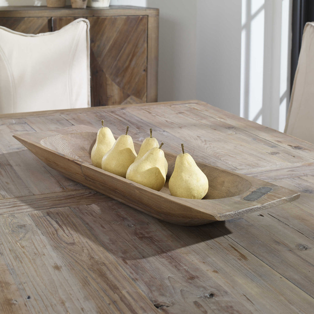 Solid reclaimed brown wood dough tray by Uttermost displayed  on table. 