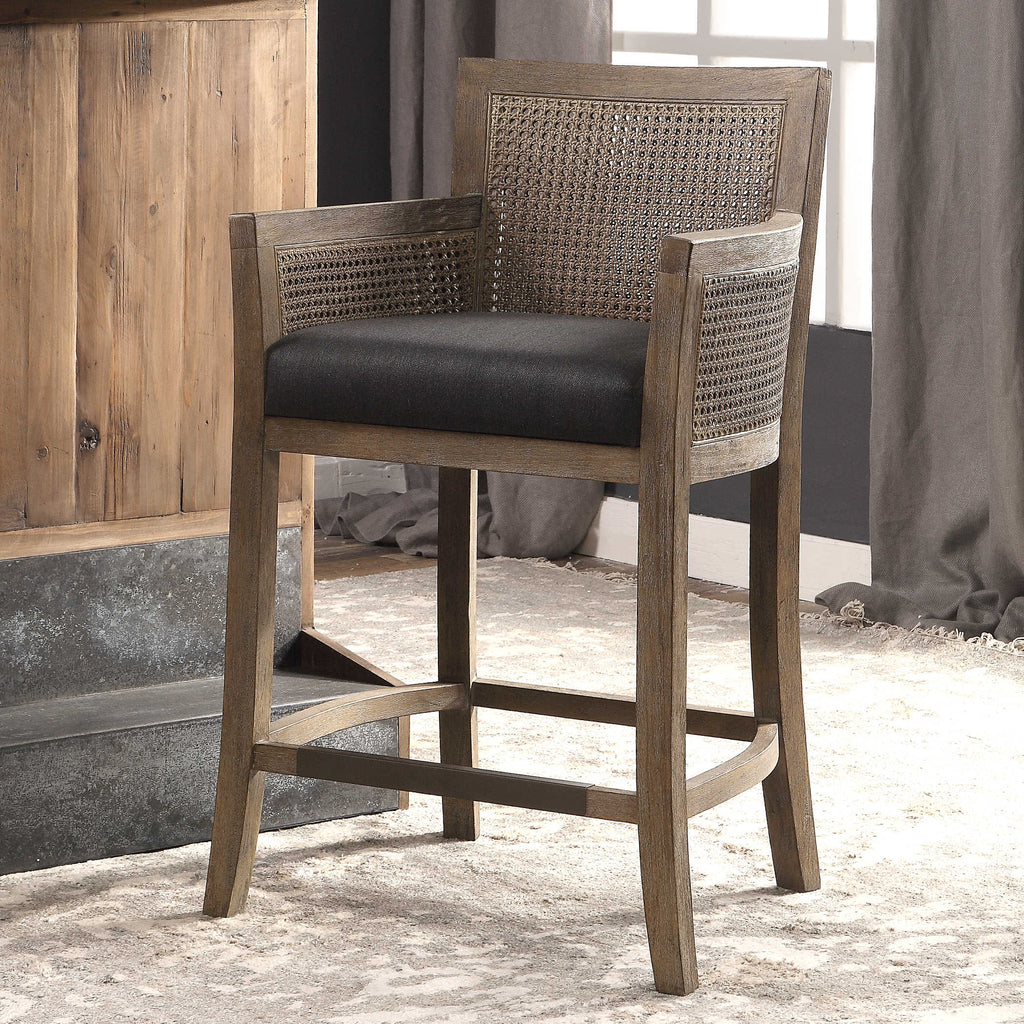 Encore counter stool by Uttermost, natural color with dark gray fabric room view.