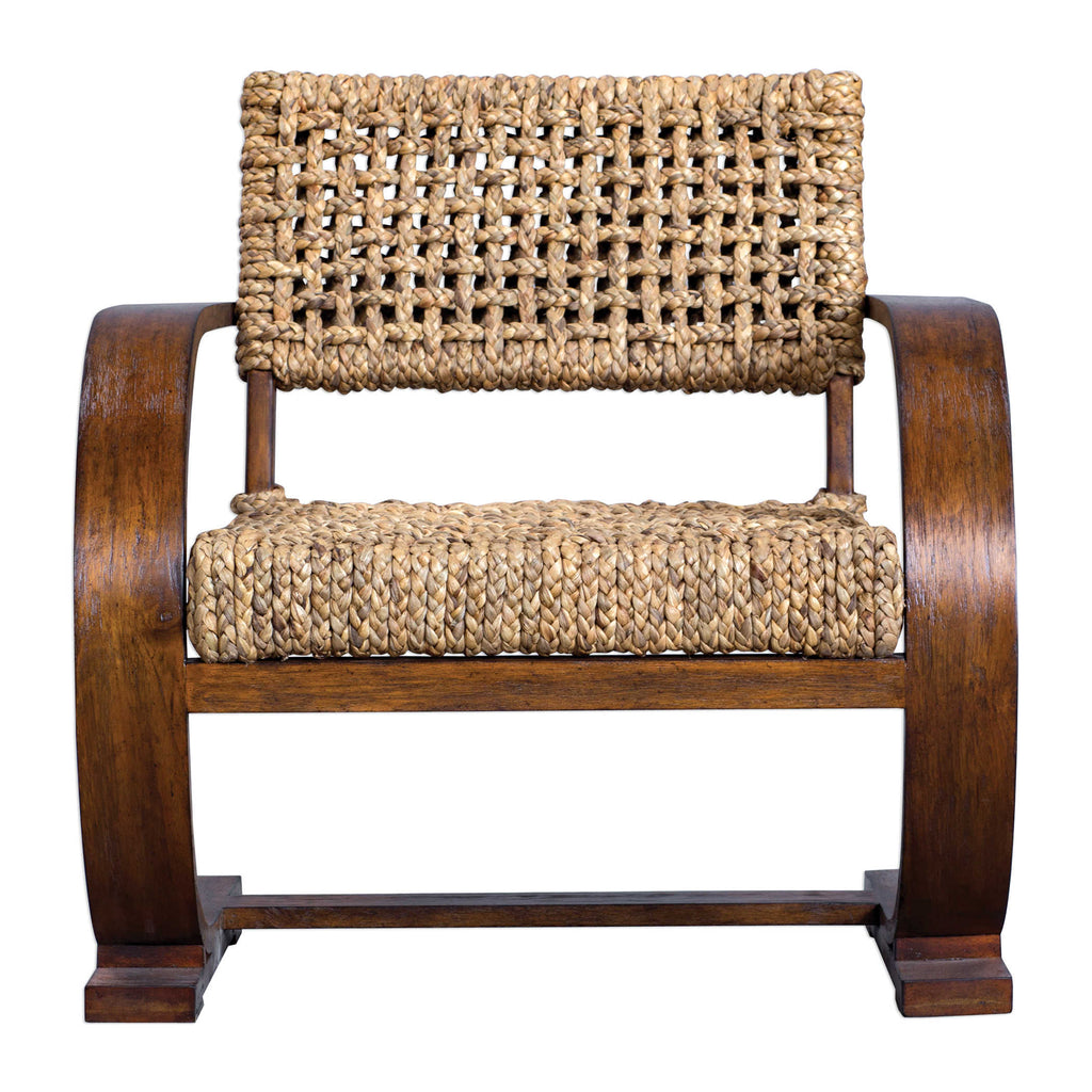 Rehema Accent Chair by Uttermost. Featuring a natural woven water hyacinth seat on a curved solid wood frame giving flexible movement, layered in a teak veneer with a smooth weathered pecan stain.