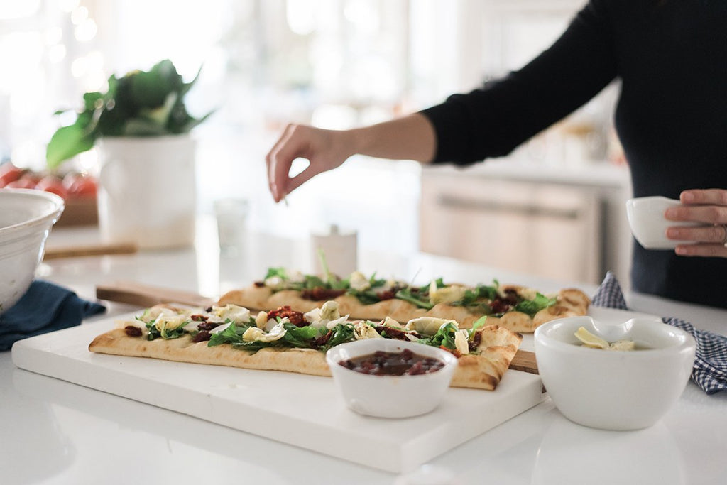 Large or small white square Italian charcuterie board. Hand-crafted from reclaimed wood, this charcuterie board’s modern yet functional design can also double as a decorative kitchen accent. Displayed as serving board.