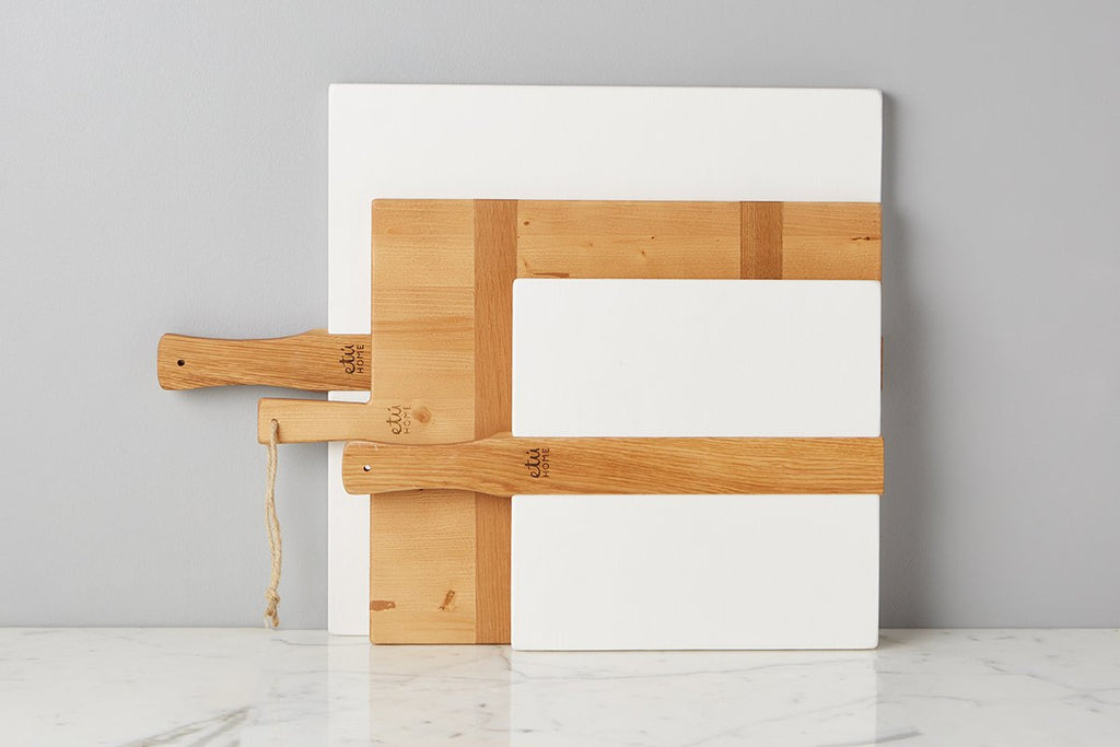 Large or small white square Italian charcuterie board. Hand-crafted from reclaimed wood, this charcuterie board’s modern yet functional design can also double as a decorative kitchen accent.  Large and small display with etúHOME collection.