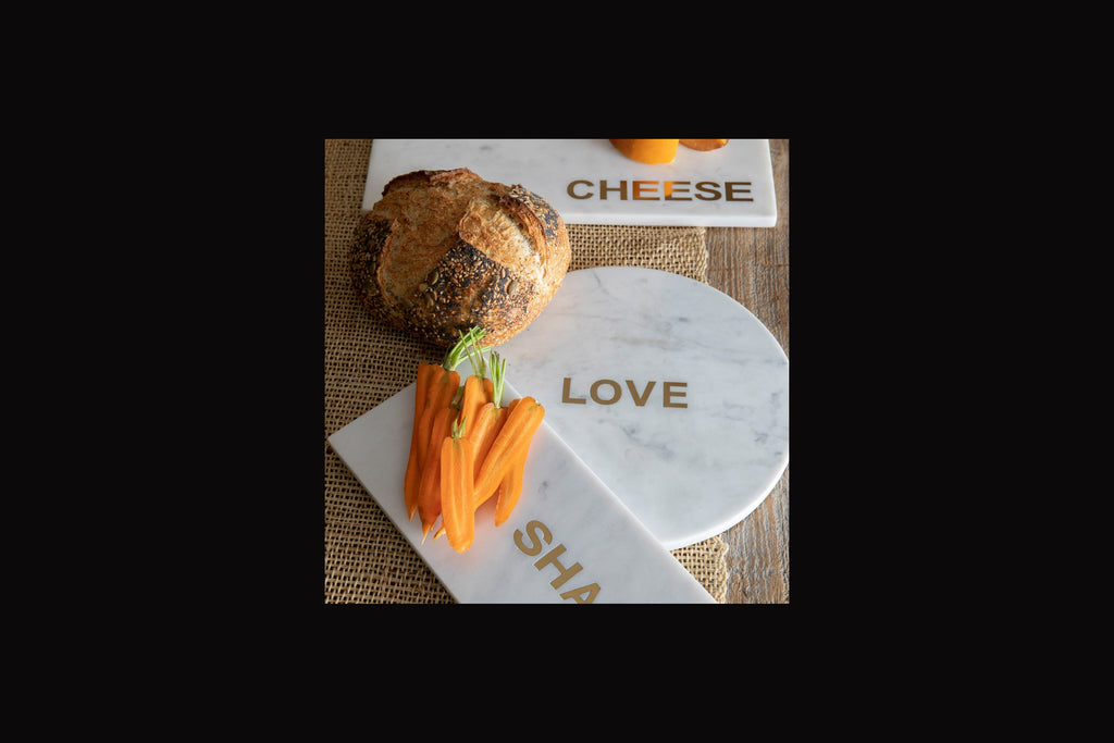 BeHome marble Love board in gold detail.  Shown as serving board for entertaining. 
